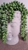 Buddha fejszobor zöld művirággal